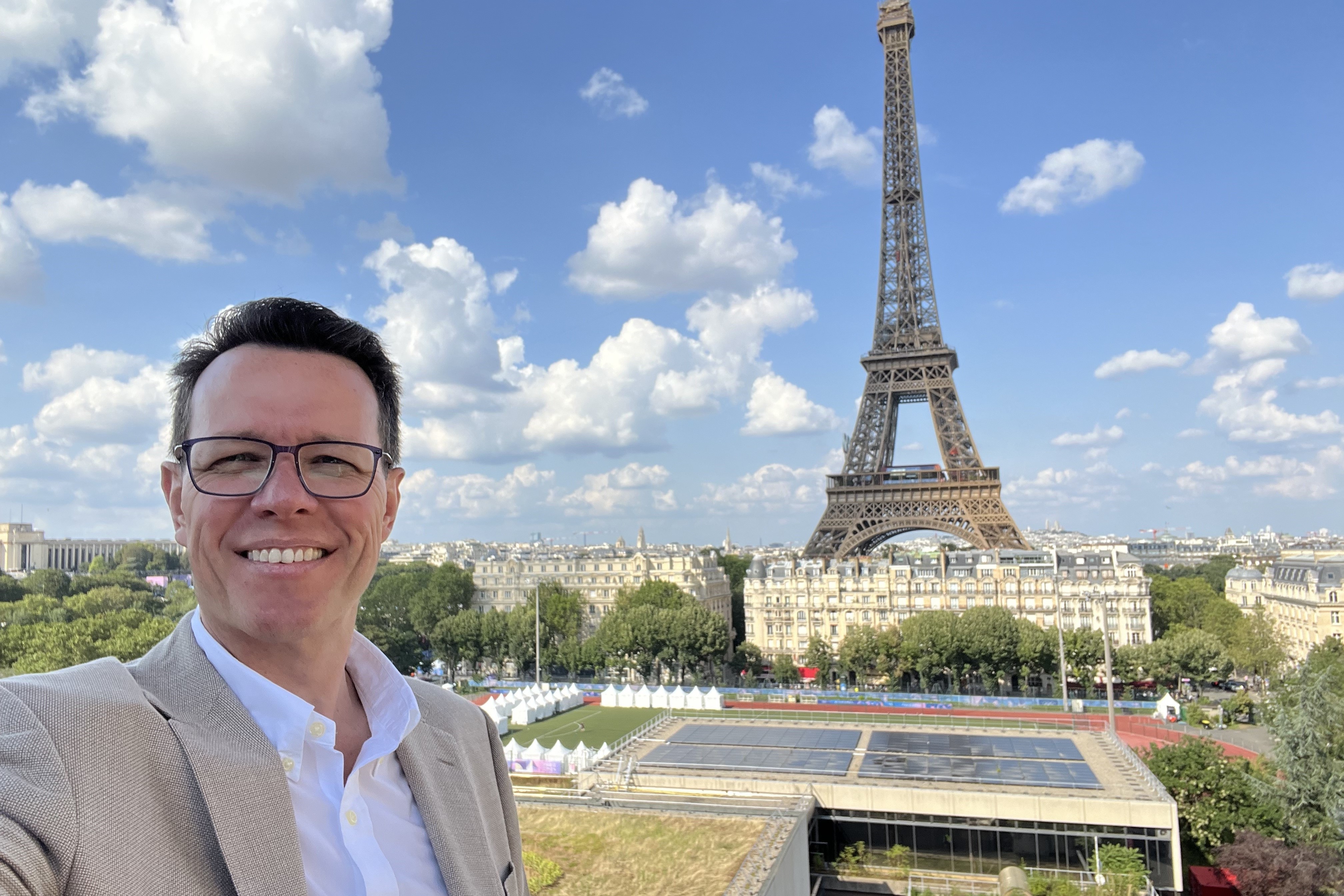 Australian Sports Commission CEO Kieren Perkins standing in front of the Eiffel Tower during the Olympics