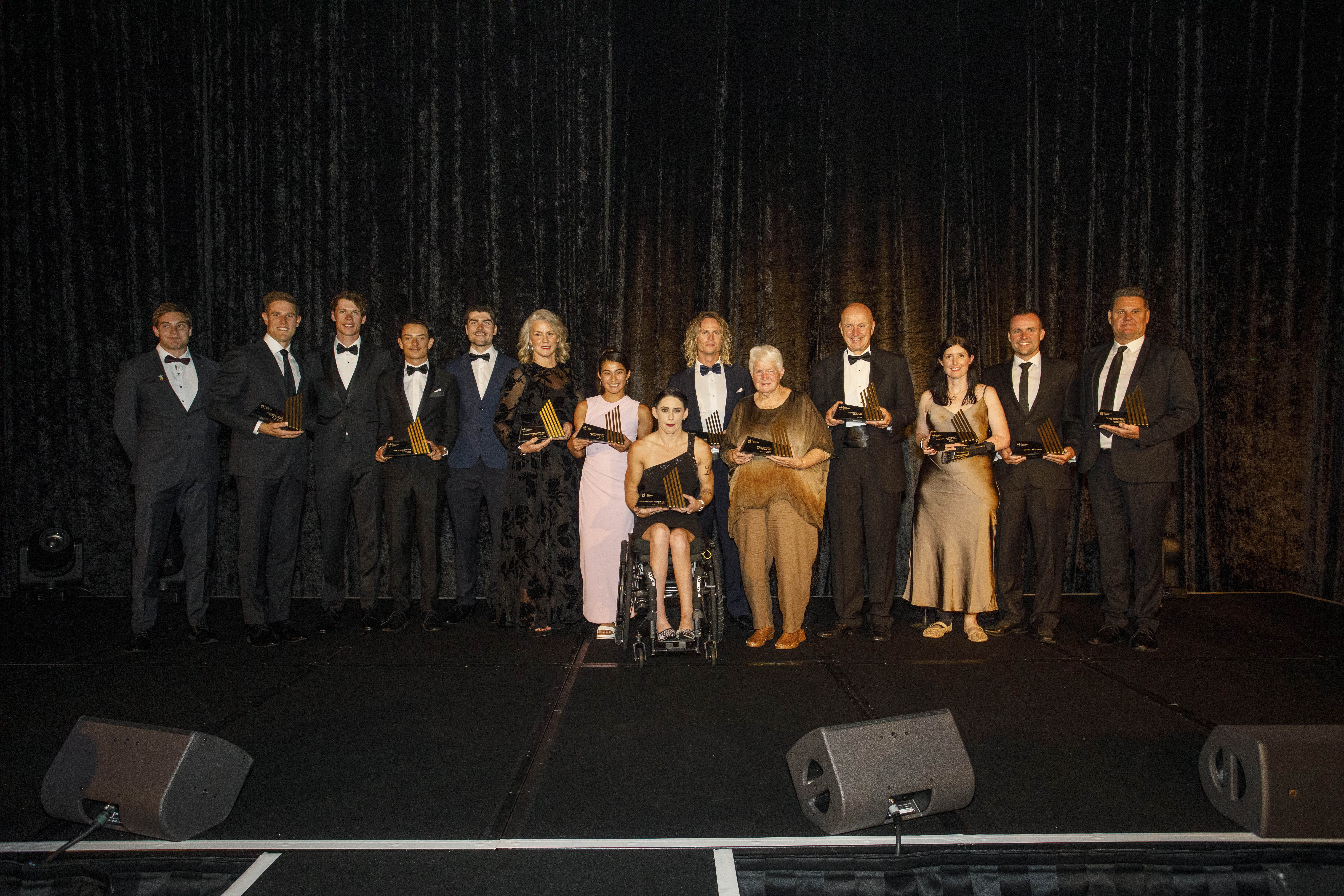 All the winners from the 2024 AIS Sports Performance Awards standing on stage with their trophies.