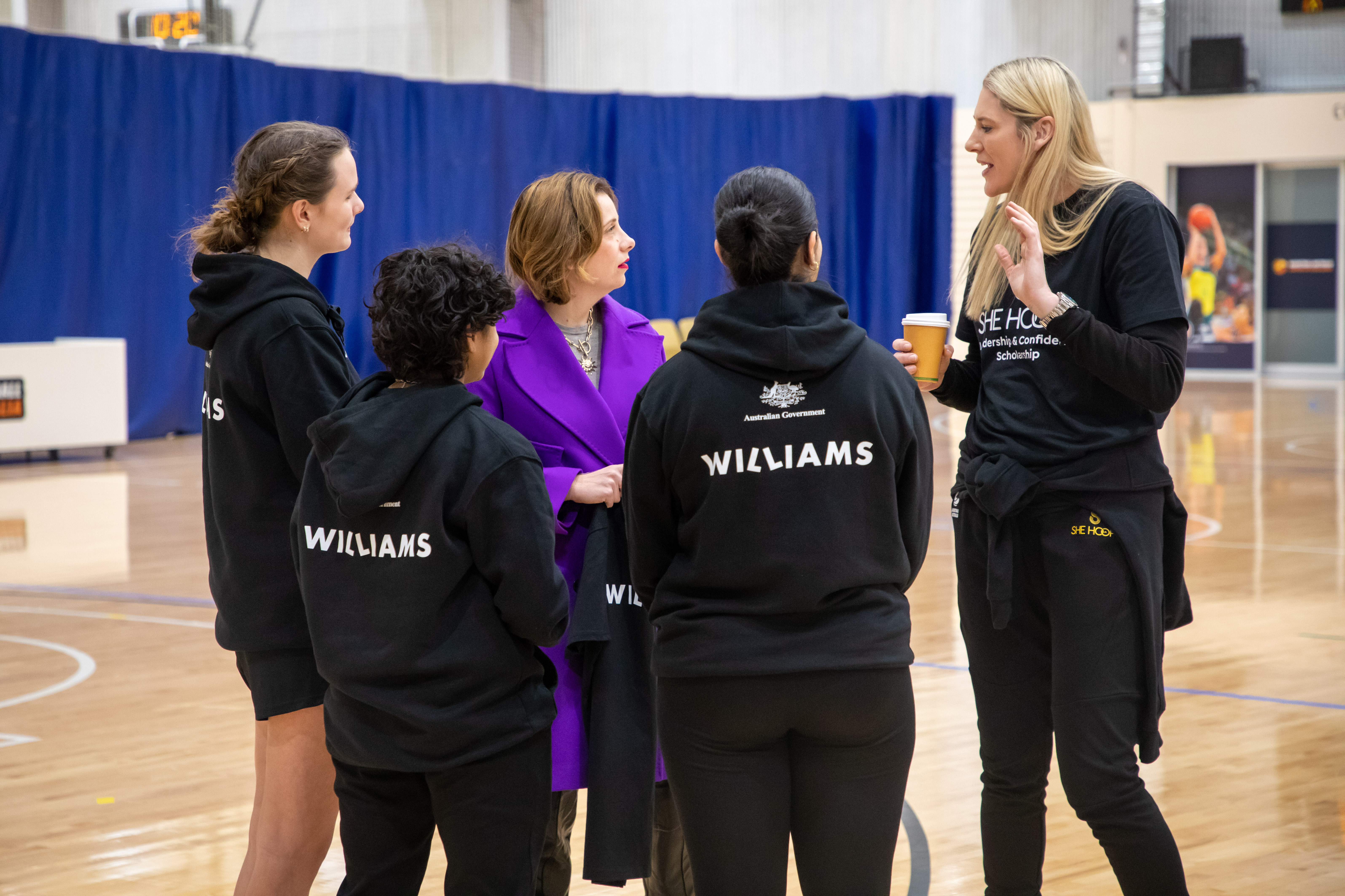 Minister for Sport Anika Wells and Lauren Jackson meet with young basketball players.