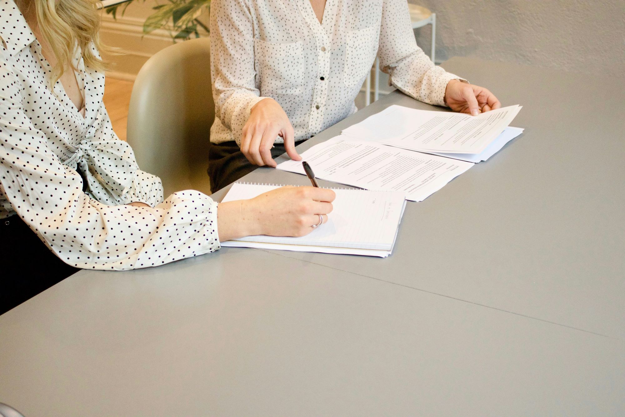 Two women in a boardroom meeting