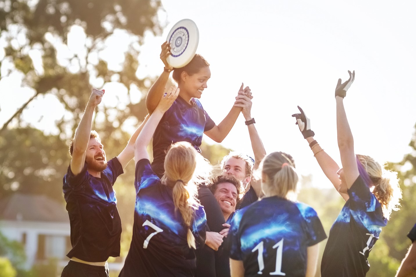 Adult frisbee team celebrating