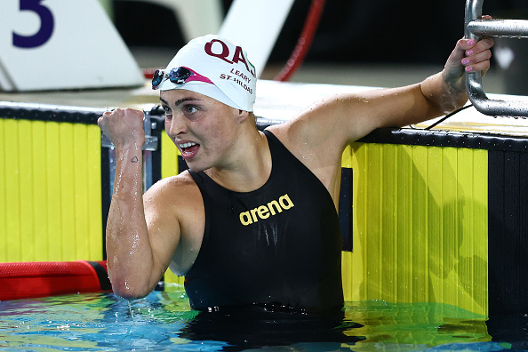 Alexa Leary celebrates in the pool after finishing a race