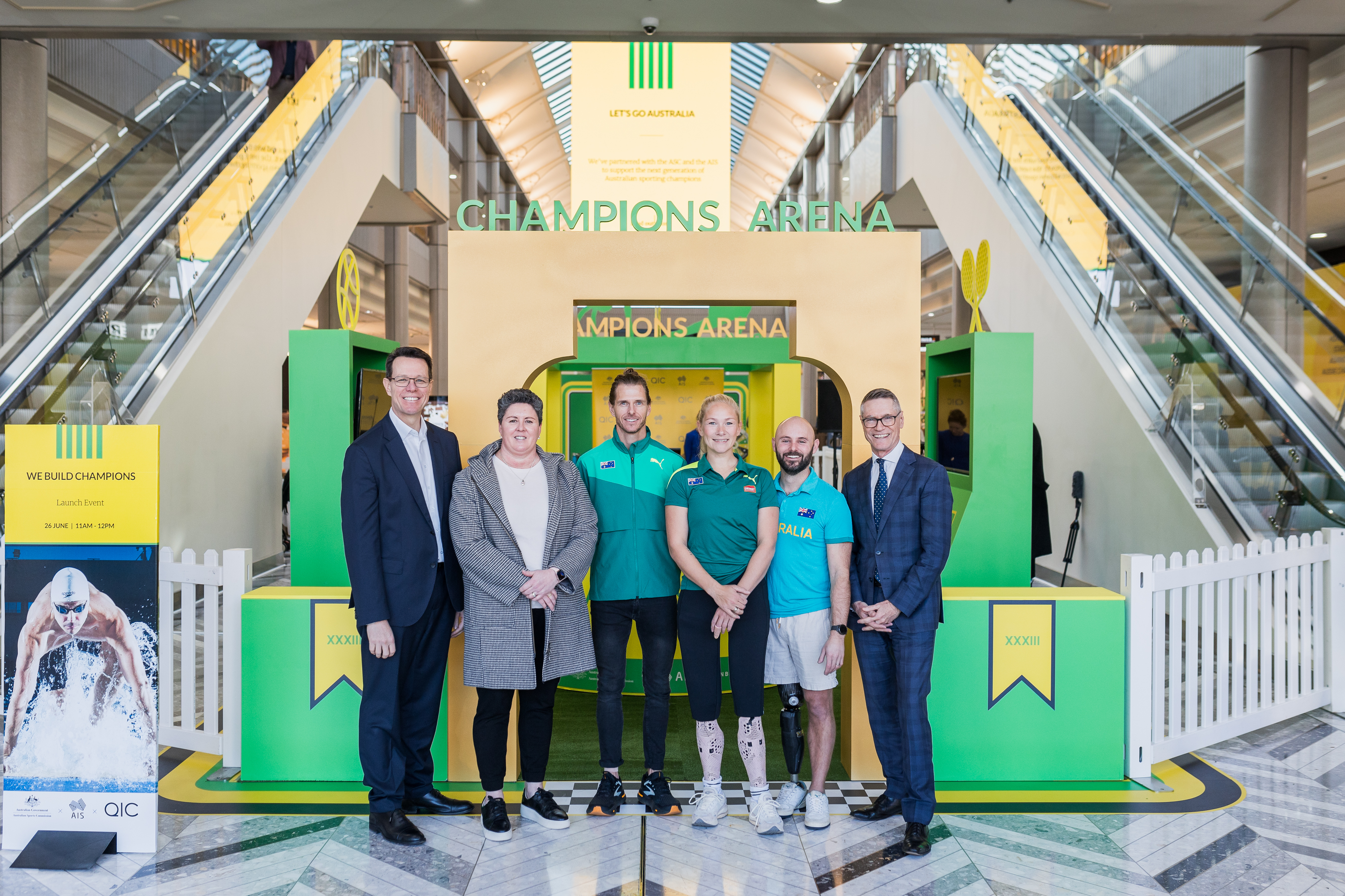 ASC CEO Kieren Perkins OAM, athletes and QIC Real Estate Managing Director Michael O’Brien standing in front of the shopping centre activation.